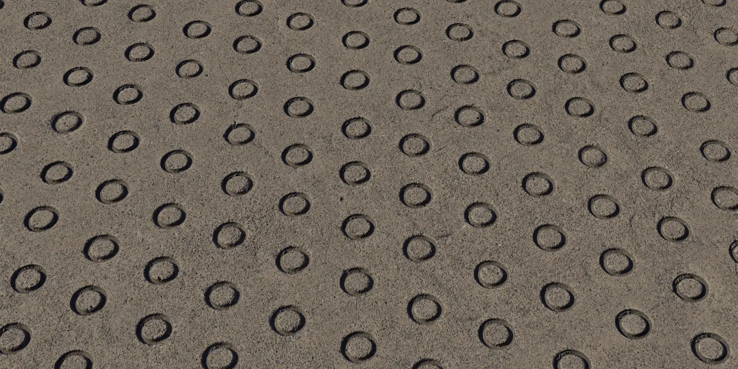 Weathered Grey Tactile Concrete Paving Texture — close-up perspective of a grey tactile concrete paving texture with circular studs